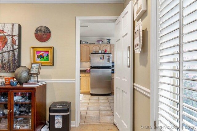 hallway featuring light tile patterned flooring and crown molding