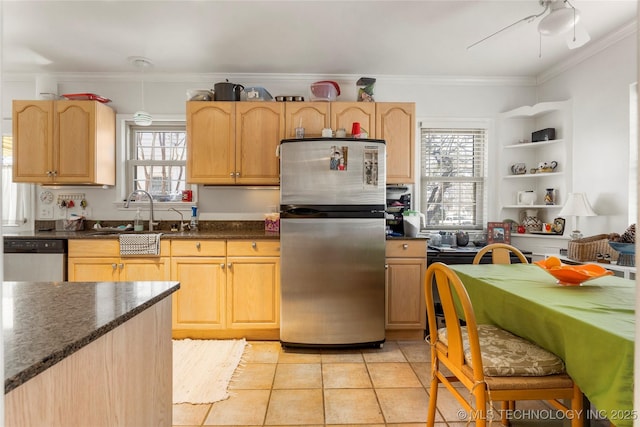 kitchen with light tile patterned flooring, appliances with stainless steel finishes, sink, and light brown cabinets