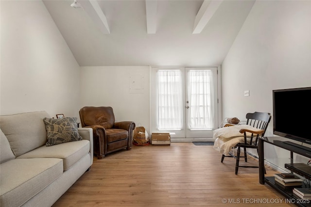 living room featuring lofted ceiling, french doors, and light wood-type flooring