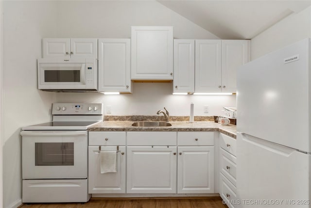 kitchen with white appliances, sink, light hardwood / wood-style flooring, and white cabinets