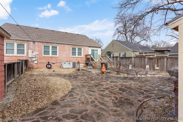 rear view of property with central AC and a patio