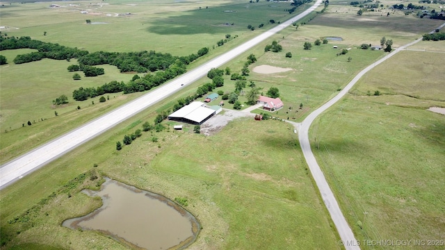 birds eye view of property with a water view and a rural view