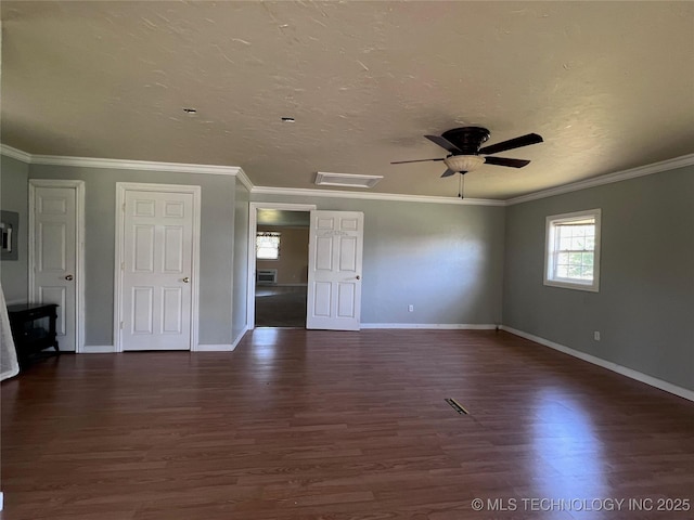 spare room with dark wood-type flooring, ceiling fan, and crown molding