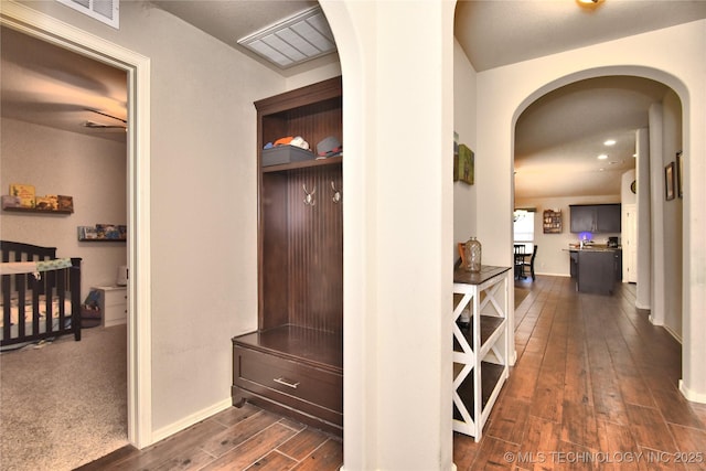 corridor with dark hardwood / wood-style flooring