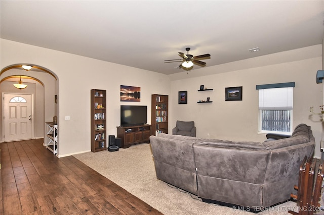 living room with ceiling fan and dark hardwood / wood-style flooring