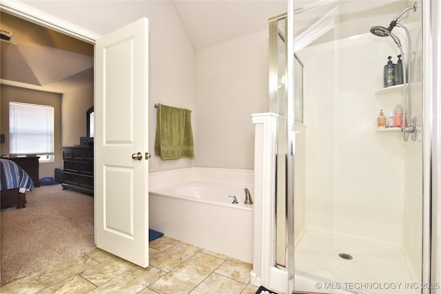 bathroom featuring vaulted ceiling, tile patterned floors, and independent shower and bath