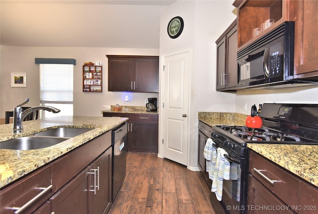 kitchen with light stone countertops, sink, dark wood-type flooring, and black appliances