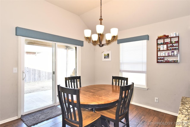 dining area with vaulted ceiling, plenty of natural light, dark hardwood / wood-style floors, and a chandelier