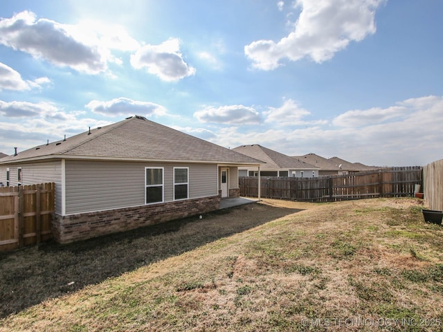 back of property featuring a yard