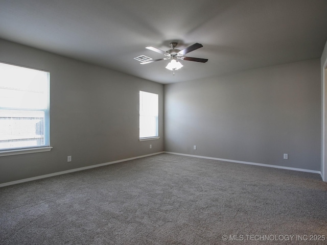 carpeted spare room featuring ceiling fan