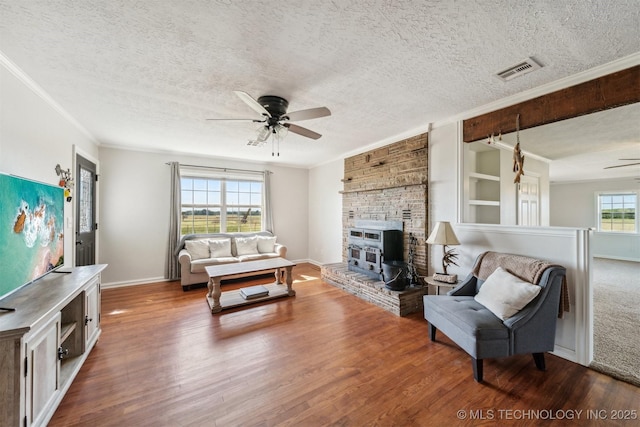 living room with ornamental molding, hardwood / wood-style floors, and a textured ceiling