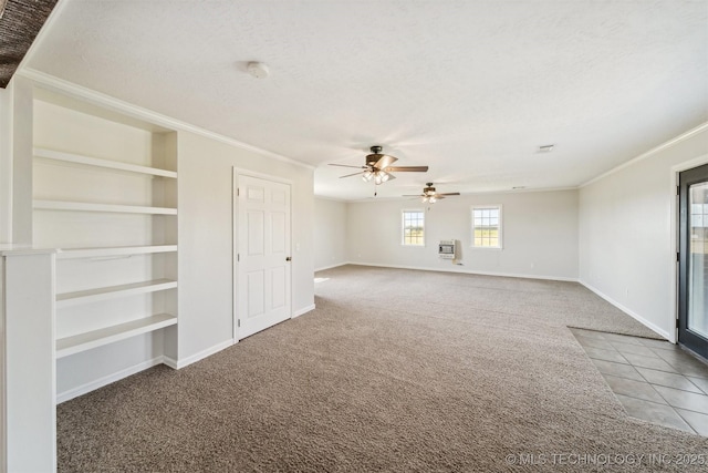 carpeted spare room with crown molding, ceiling fan, and a textured ceiling