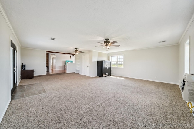 unfurnished living room featuring crown molding, carpet floors, a textured ceiling, and ceiling fan