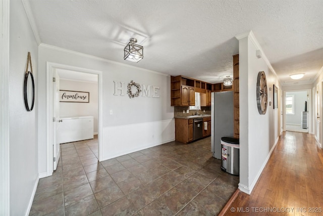 kitchen with ornamental molding, dishwasher, sink, and a textured ceiling