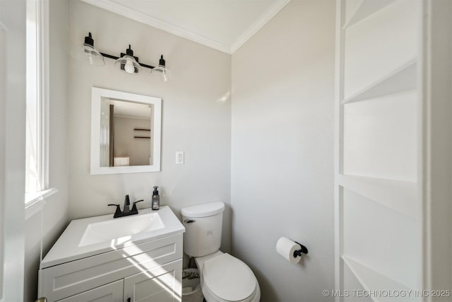 bathroom featuring crown molding, vanity, and toilet