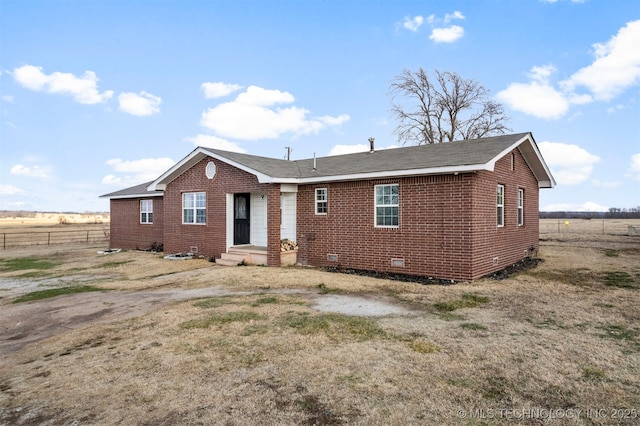 rear view of house with a rural view