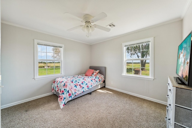bedroom with baseboards, visible vents, carpet floors, and ornamental molding