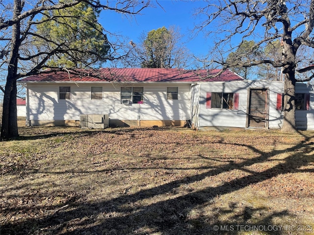 rear view of property with a lawn