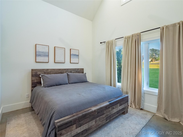 bedroom featuring high vaulted ceiling