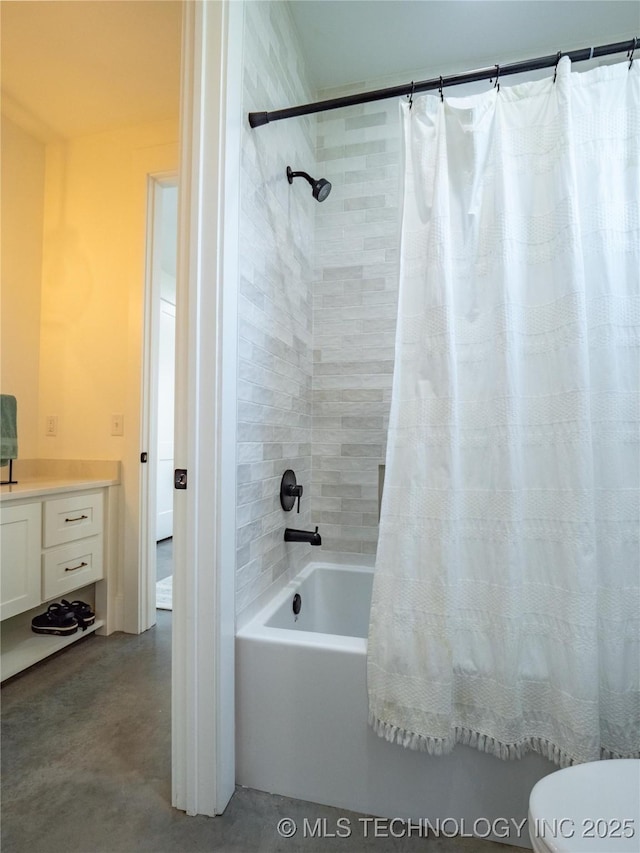 bathroom featuring vanity, shower / bath combo with shower curtain, and concrete floors