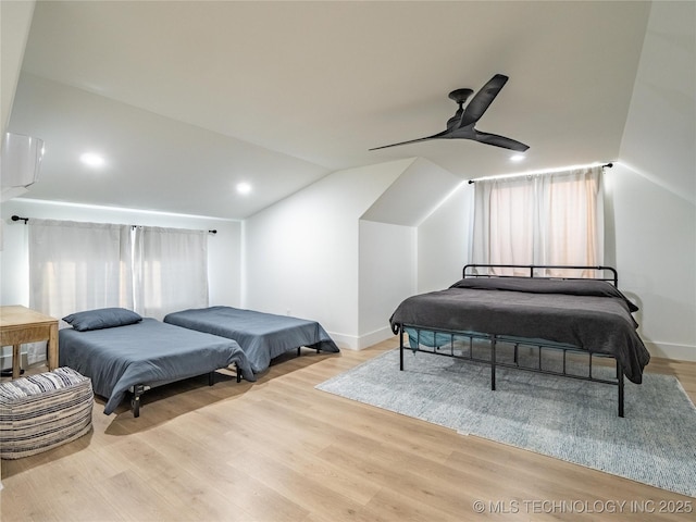 bedroom featuring lofted ceiling, light hardwood / wood-style flooring, and ceiling fan