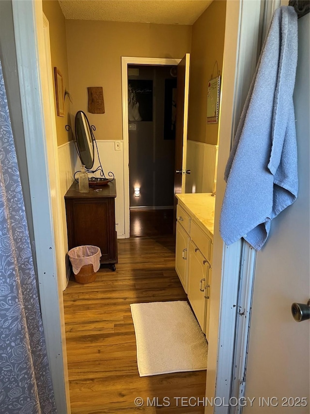 bathroom with vanity, hardwood / wood-style flooring, and a textured ceiling