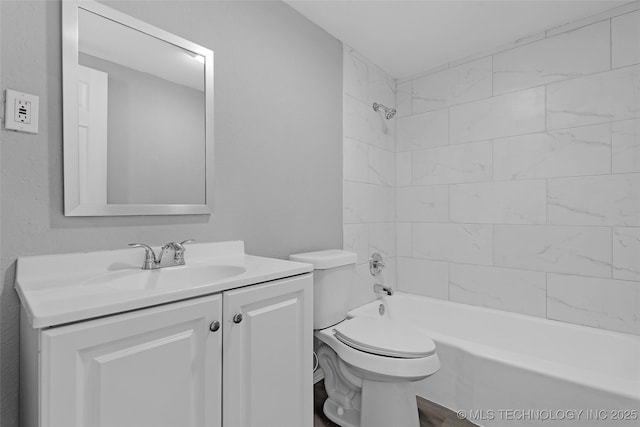 full bathroom featuring tiled shower / bath combo, vanity, and toilet