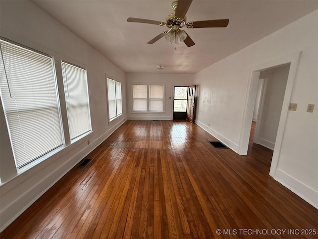 unfurnished living room featuring dark hardwood / wood-style flooring and ceiling fan