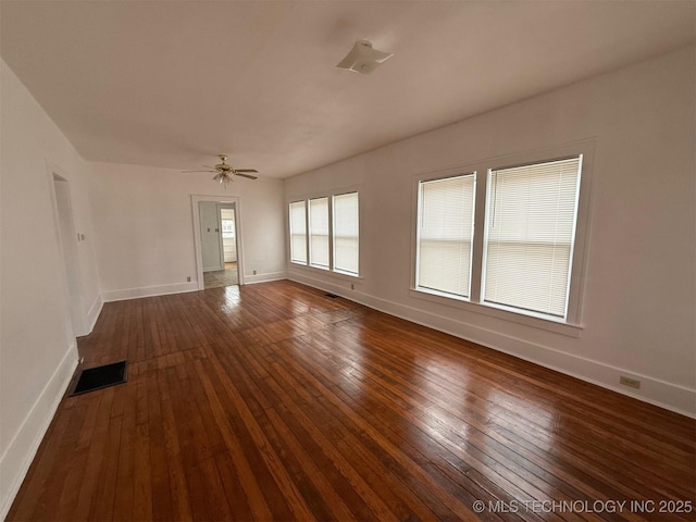 empty room with dark hardwood / wood-style floors and ceiling fan