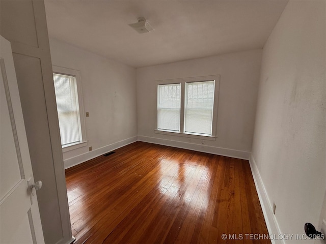 unfurnished room with dark wood-type flooring and a healthy amount of sunlight