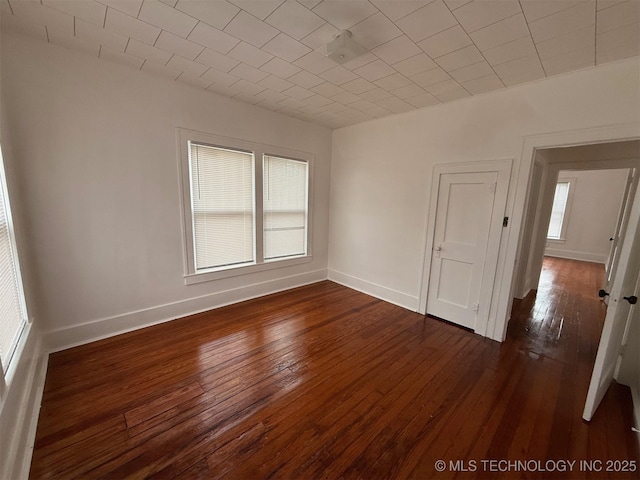 unfurnished room with dark hardwood / wood-style floors