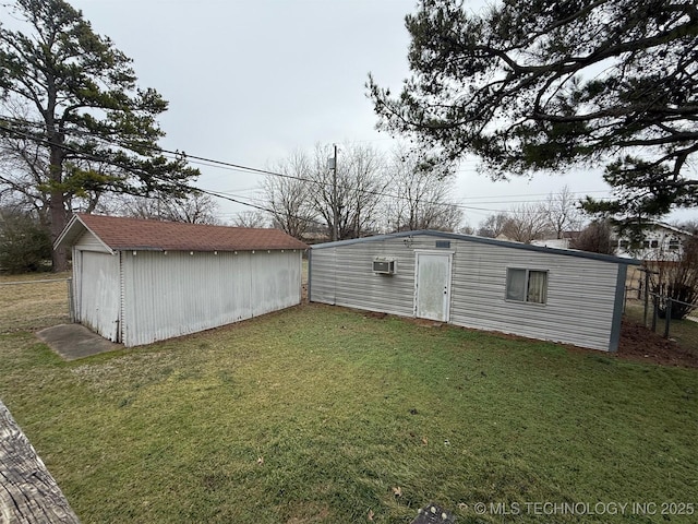 view of yard featuring a wall mounted air conditioner and an outdoor structure