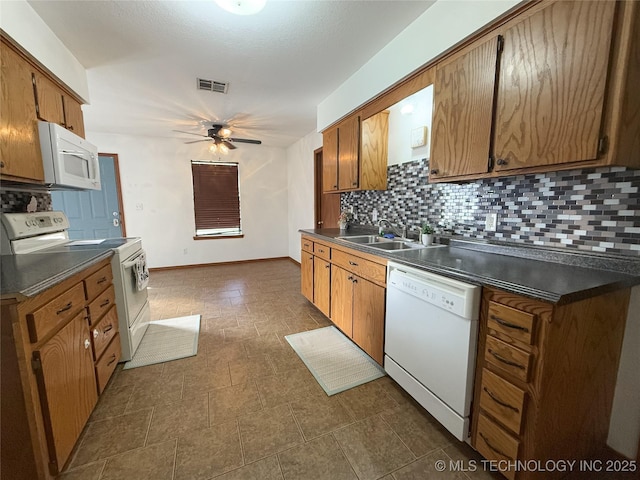 kitchen featuring ceiling fan, white appliances, sink, and tasteful backsplash