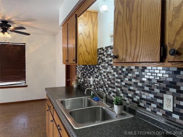 kitchen with tasteful backsplash, ceiling fan, and sink