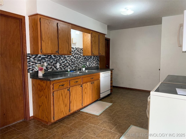 kitchen featuring white dishwasher, sink, backsplash, and stove