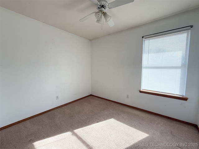 carpeted empty room featuring ceiling fan