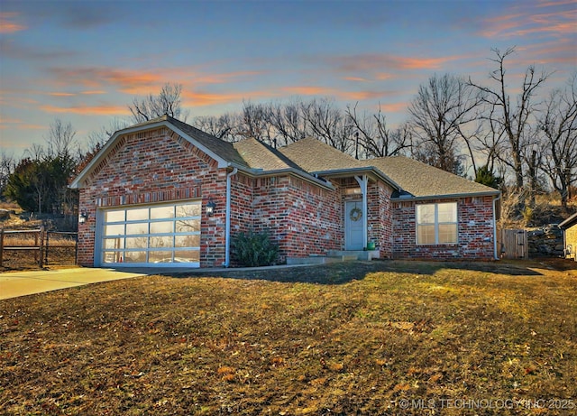 view of front of property featuring a yard and a garage