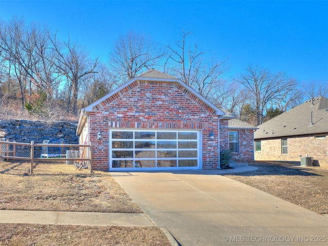 view of front of house with central AC unit and a garage