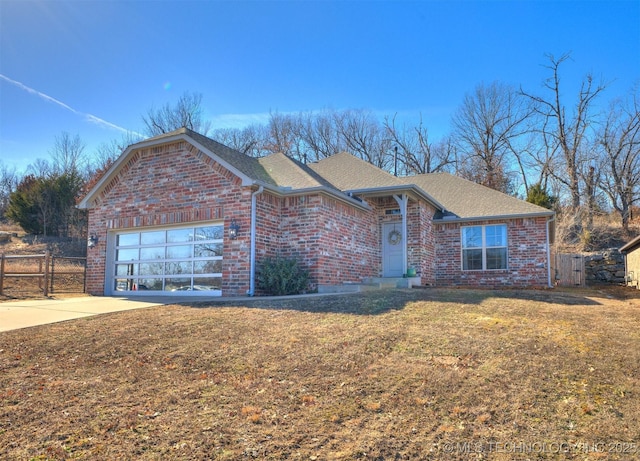 view of front of property featuring a garage and a front yard