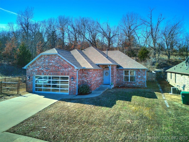 view of front of house featuring a garage, central air condition unit, and a front lawn