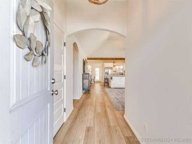 entryway with lofted ceiling and light hardwood / wood-style flooring