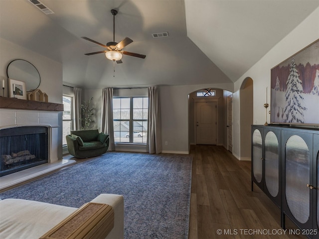 living room featuring lofted ceiling, dark hardwood / wood-style floors, and ceiling fan