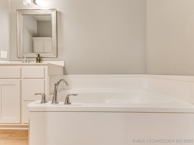 bathroom with vanity and a bathing tub