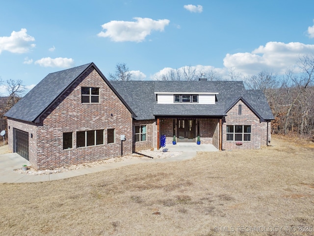 view of front of property with a garage and a front yard