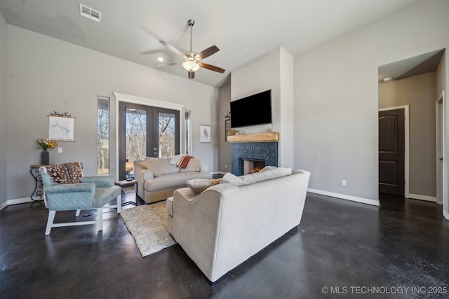 living room with french doors, ceiling fan, and vaulted ceiling