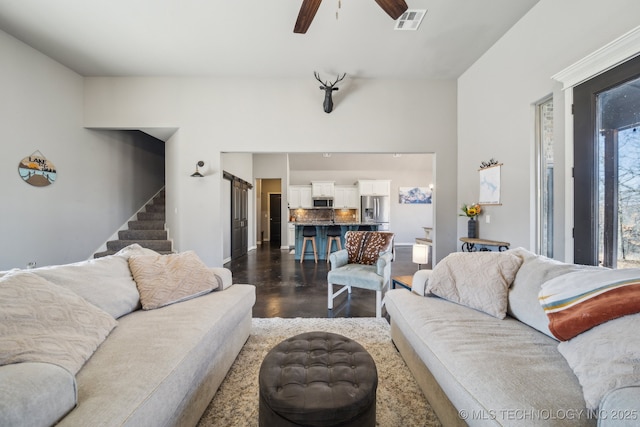 living room featuring ceiling fan and dark hardwood / wood-style floors