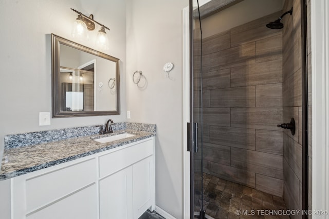 bathroom with vanity and a shower with shower door