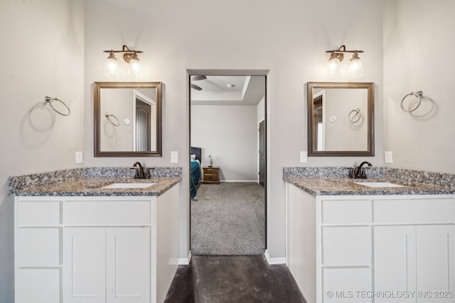 bathroom featuring vanity and a tray ceiling