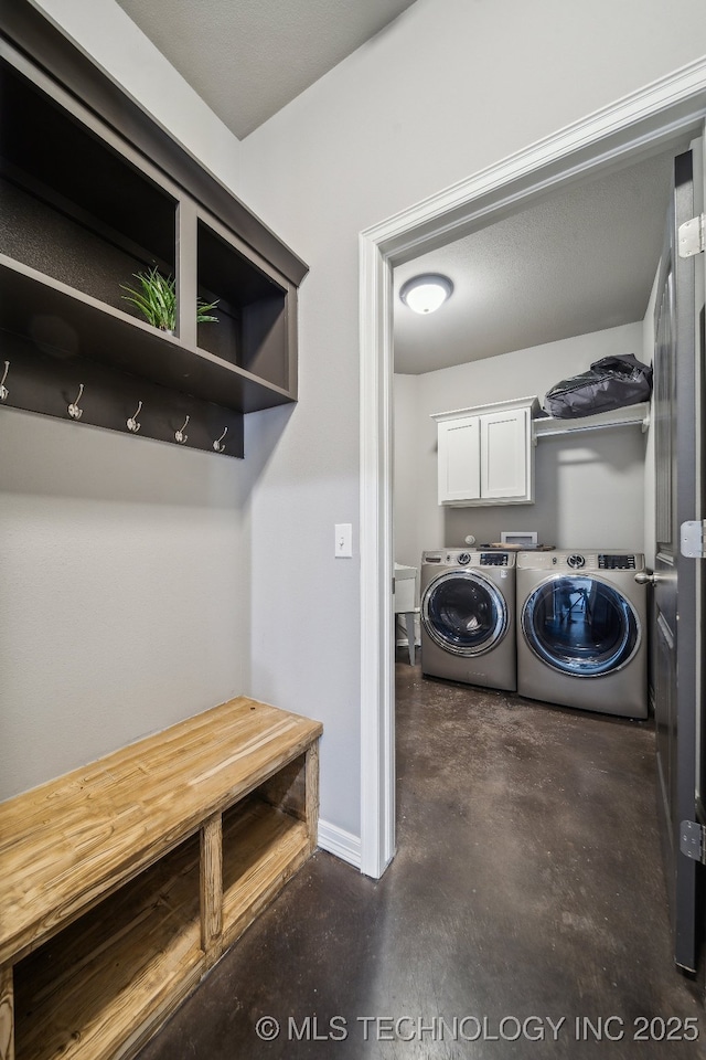 laundry room with cabinets and washing machine and clothes dryer