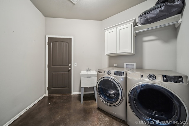 washroom featuring cabinets and separate washer and dryer